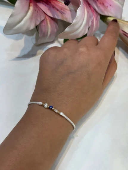 دستبند گوی طلا با بند سفید