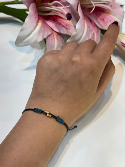 دستبند گوی طلا با بند قهوه ای